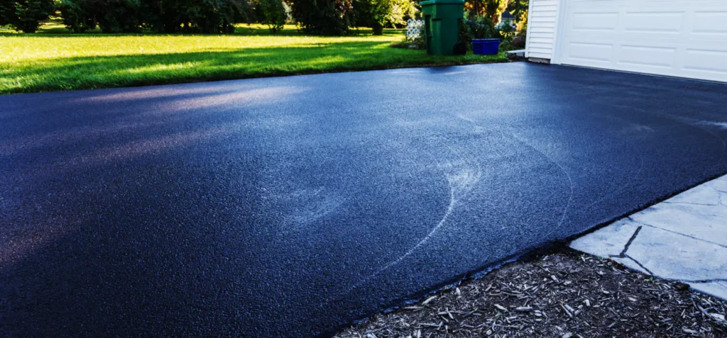 a-fresh-sealing-coat-just-finished-on-this-asphalt-driveway-in-suburban-residential-district