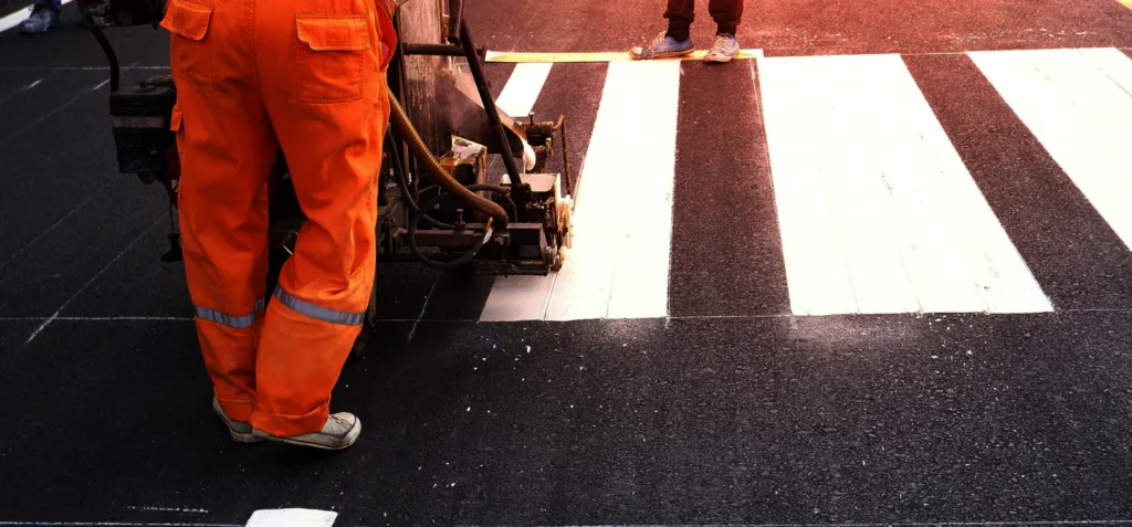 road-workers-using-thermoplastic-spray-road-marking-machine chandler az